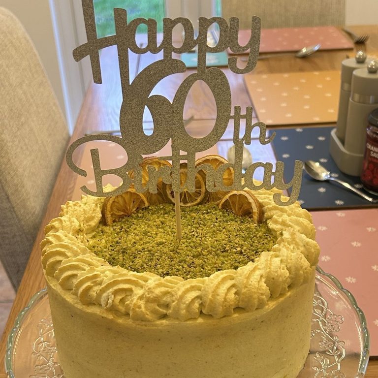 Lemon & Pistachio Birthday cake topped with Happy 60th Birthday