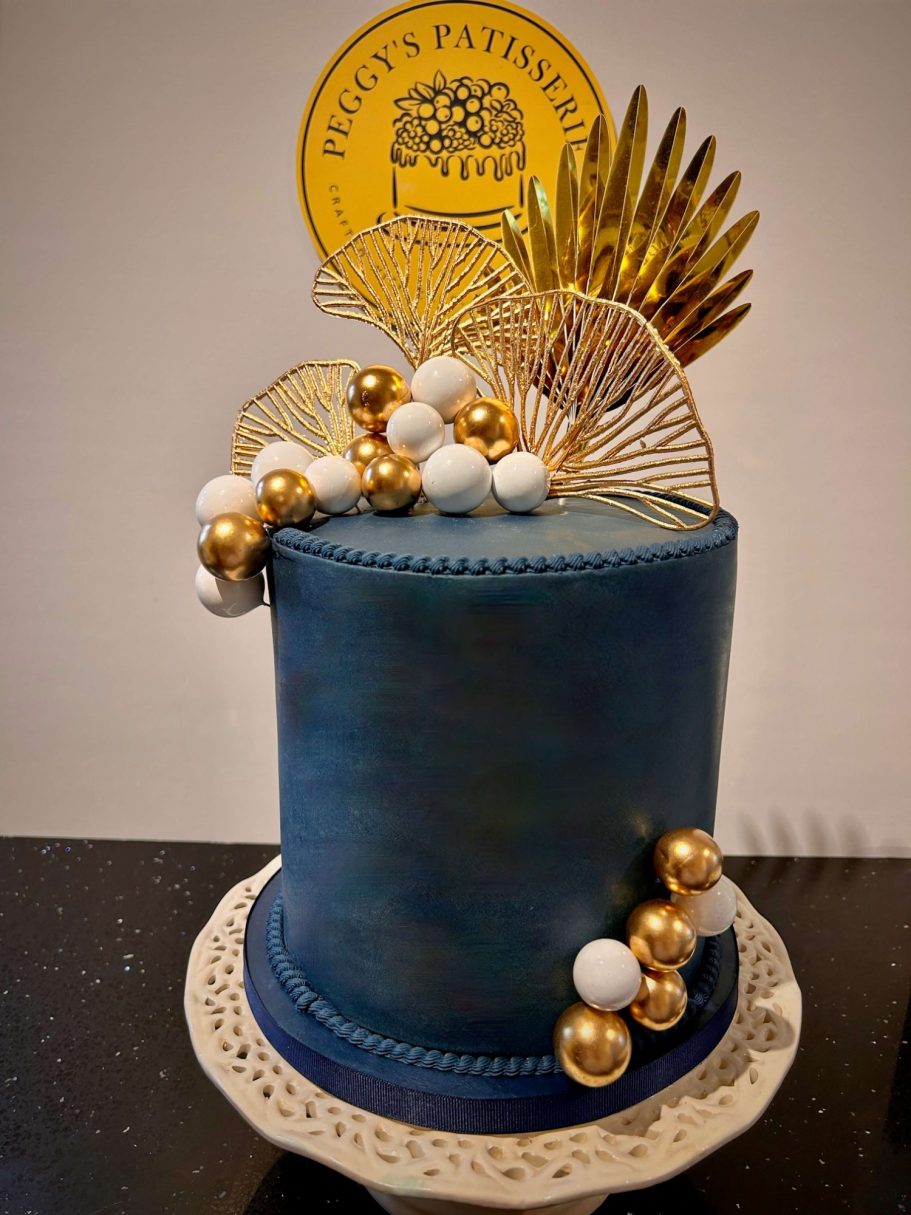 Navy Blue and Golden Classic Tall navy blue and golden cake decorated with gold and cream spheres and fans