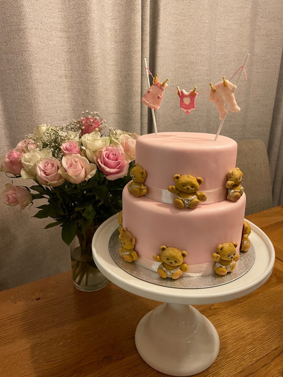 Pink two tier cake with decorated with hand made sugar craft teddies Pink two tier cake with decorated with hand made sugar craft teddies