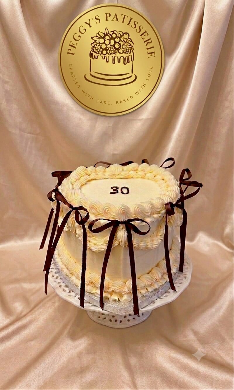 Lambeth 30th Heart shaped buttercream 30th birthday cake decorated with Lambeth style piping and brown ribbon bows