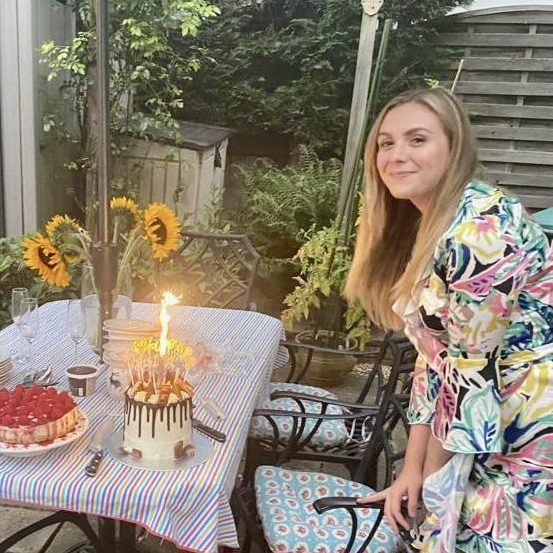 Happy woman with candle-lit birthday cake