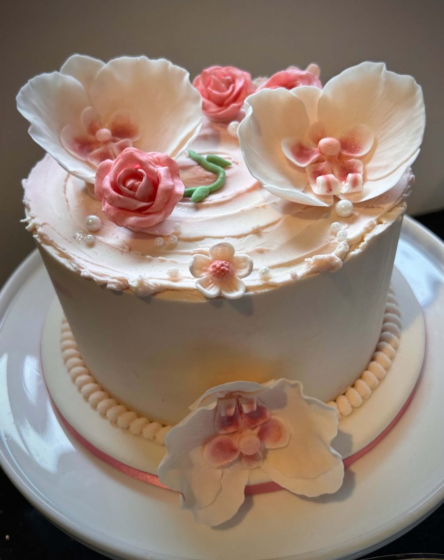Orchid Edible WEegance Sugar-flower topped pink buttercream cake