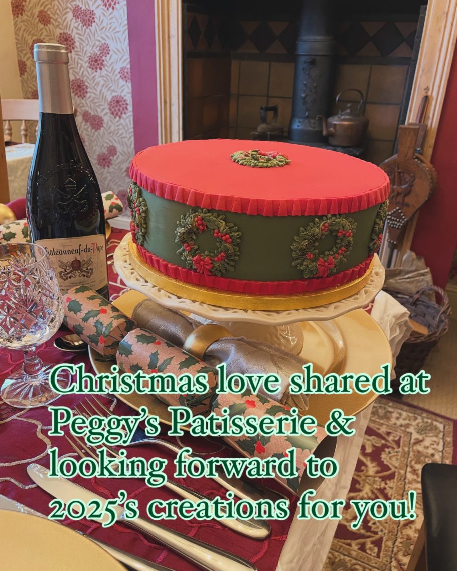 Red & green iced Christmas cake Delicate garlanded red and green iced Christmas cake