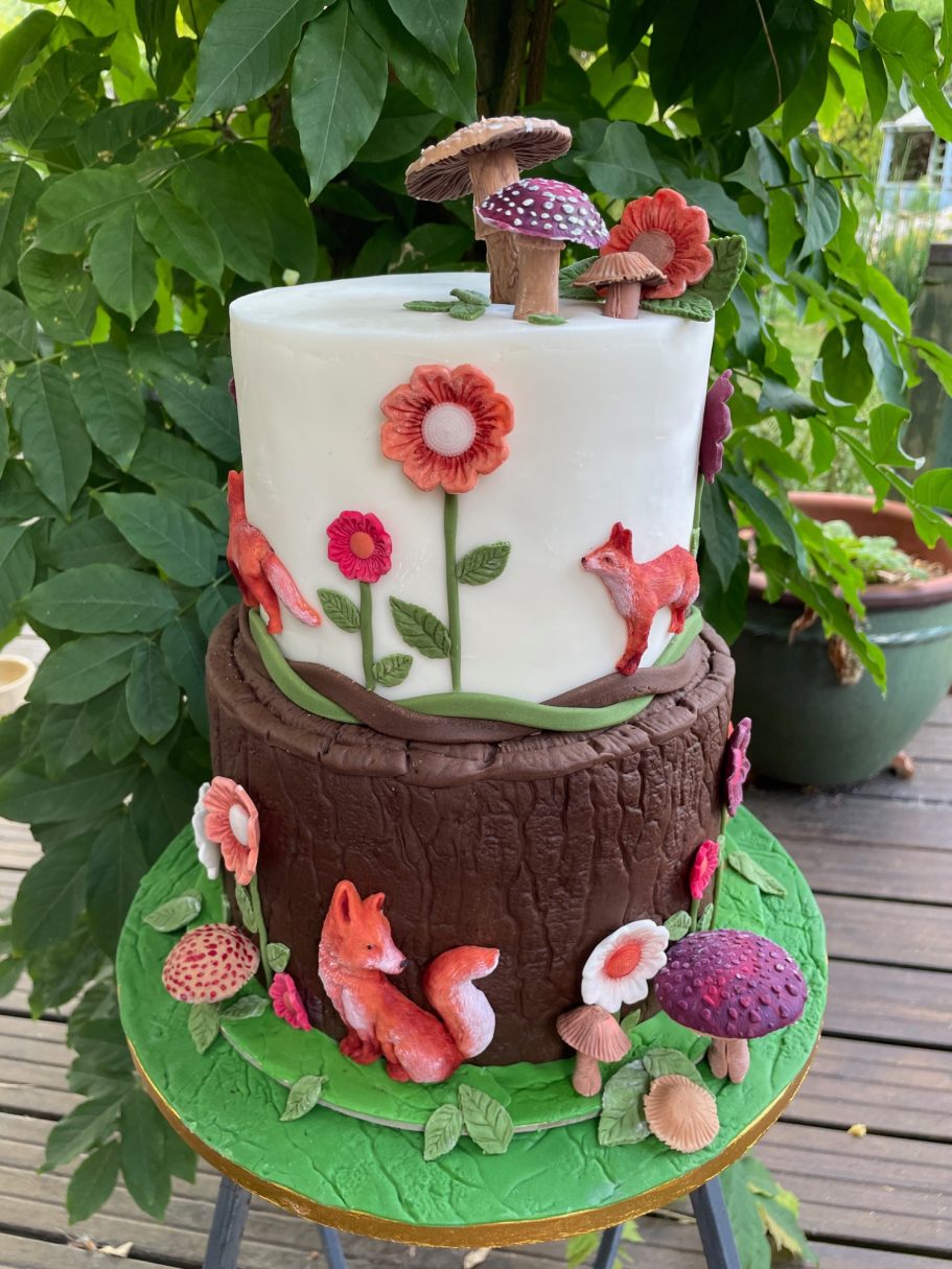 Foxes in the Wood Two tier cake decorated with foxes flowers and mushrooms